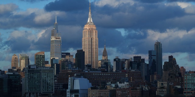 The sun sets on the Empire State Building, One Vanderbilt and the Chrysler Building in New York City on March 14, 2021, as seen from Jersey City, New Jersey.
