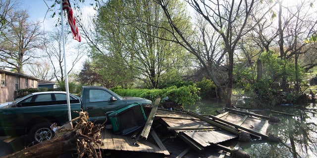 Debris lies in the backyard yard outside a home in Nashville on Sunday. Flash flooding along Sevenmile Creek the night before caused major damage in the South Nashville neighborhood. (Reuters)
