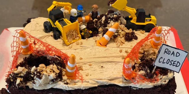 Inspired, the nurse baked a "replica" cake complete with construction worker Legos, miniature Cat trucks, traffic safety equipment and a "road closed" sign.