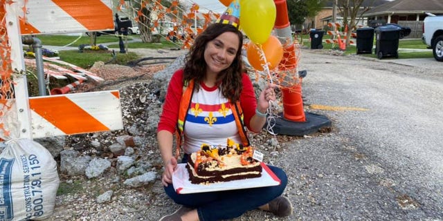 The NOLA resident posed in front of the real-life nuisance with balloons and a party hat.