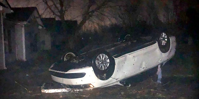 A vehicle flipped on its roof and covered in debris after a tornado touched down in Newnan, Georgia, early Friday March 26, 2021. (@@charityislove via AP)