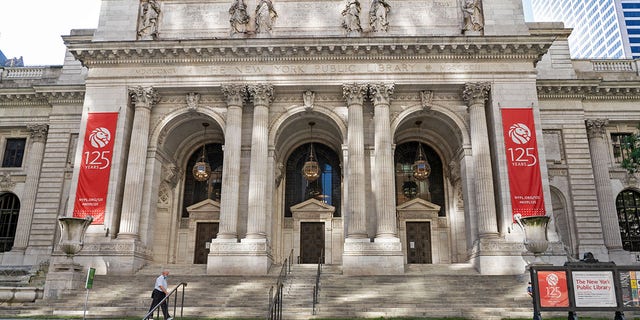 An exterior view of New York Public Library on Fifth Avenue in New York, in an image dated 7/13/2020. The New York Public Library's stone lions Patience and Fortitude have donned face masks to remind New Yorkers to wear face coverings during the COVID-19 pandemic. (Photo by Ron Adar/SOPA Images/LightRocket via Getty Images)
