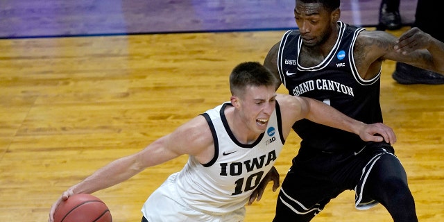 Iowa's Joe Wieskamp (10) guarded by Oscar Frayer in their tournament game Saturday, March 20, 2021, at the Indiana Farmers Coliseum in Indianapolis. (AP Photo/Charles Rex Arbogast)