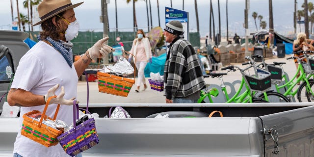 Celebrity men's groomer Jason Schneidman giving out Easter baskets full of supplies to the homeless in Venice, California.