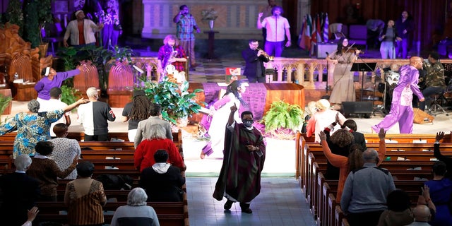 Pastor Thulani Magwaza leads the Sunday church service at St. Sabina Catholic Church on March 7. (AP)