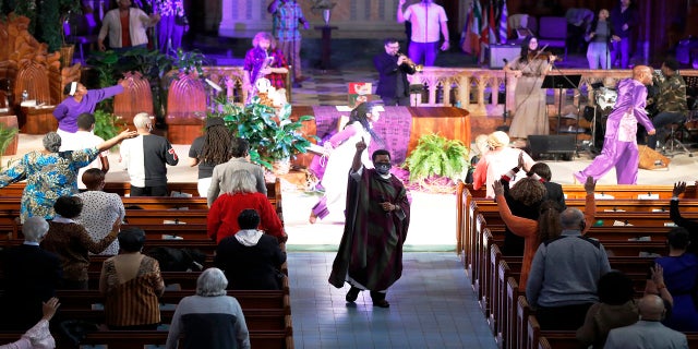 Pastor Thulani Magwaza leads the Sunday church service at St. Sabina Catholic Church on March 7. (AP)