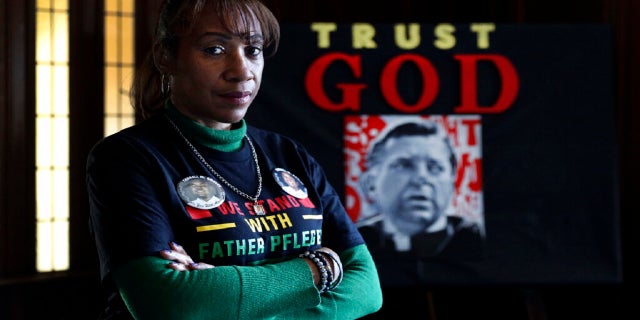 Activist Pam Bosley poses for a portrait infront of a portraiture of Father Michael Pfleger, inside the St. Sabina Catholic Church on March 4. (AP)
