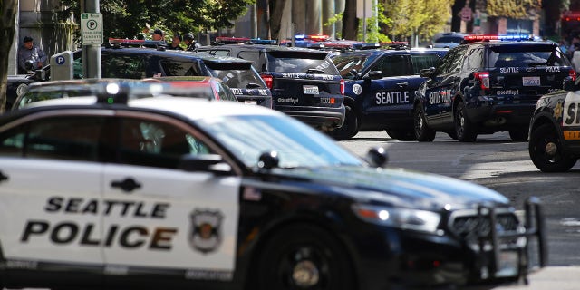 Officers respond after two Seattle Police Department officers were shot while responding to a robbery in downtown Seattle on Thursday, April 20, 2017. (Photo by GENNA MARTIN/San Francisco Chronicle via Getty Images)