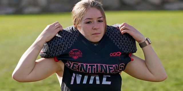 Sam Gordon puts on her shoulder pads in Herriman, Utah, in this Oct. 20, 2020, file photo. (AP Photo/Rick Bowmer, File)