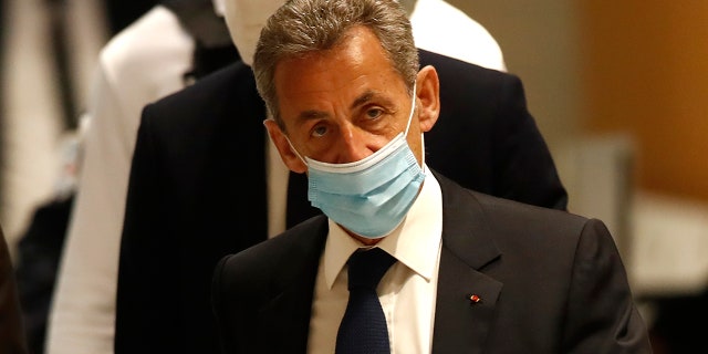 Former French President Nicolas Sarkozy arrives at the courtroom Monday, March 1, 2021 in Paris. (AP Photo/Michel Euler)