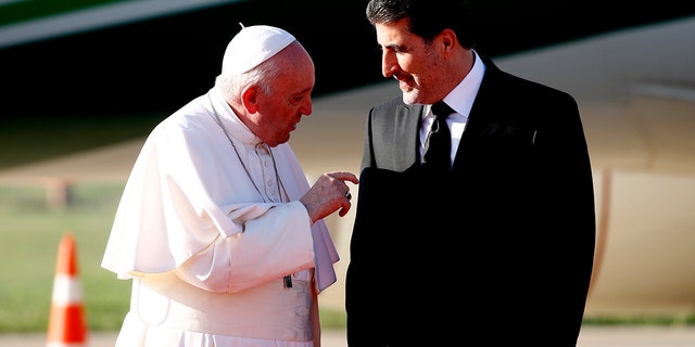 Kurdish President Nechirvan Barzani, right, greets Pope Francis upon his arrival in Irbil international airport, Iraq, Sunday, March 7, 2021. (Associated Press)