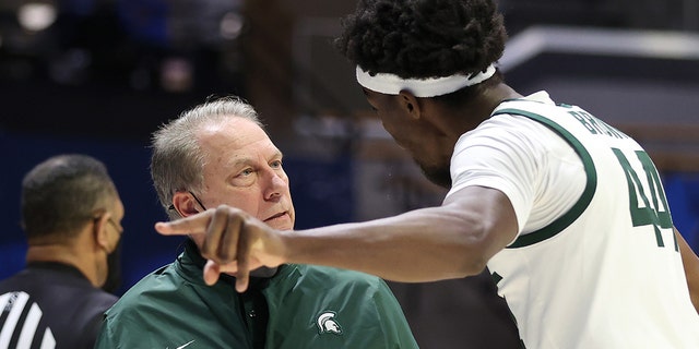 Michigan State Spartans head coach Tom Izu talks with Gabe Brown at Mackie Arena on March 18, 2021 in West Lafayette, Indiana. 