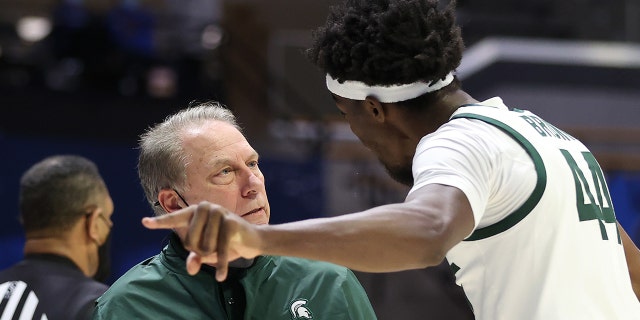 Head coach Tom Izzo of the Michigan State Spartans talks with Gabe Brown at Mackey Arena on March 18, 2021 in West Lafayette, Indiana.
