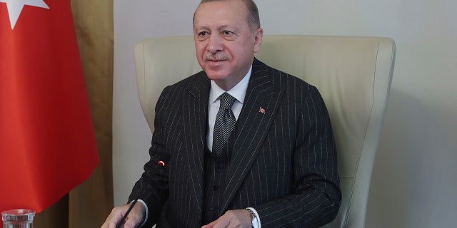 Turkey's President Recep Tayyip Erdogan speaks as he participates in a video conference with European Commission President Ursula von der Leyen and European Council President Charles Michel, from an old Ottoman palace, in Istanbul, Friday, March 19, 2021.