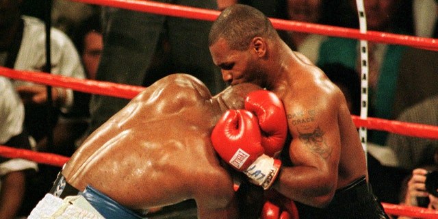 Mike Tyson bites the ear of Evander Holyfield during the third round of the WBA Heavyweight Championship fight in Las Vegas, June 28. The fight was called after Tyson was disqualified. PP05060142  SPORT BOXING