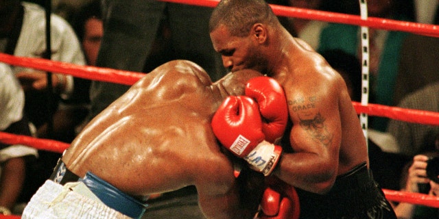 Mike Tyson bites the ear of Evander Holyfield during the third round of the WBA Heavyweight Championship fight in Las Vegas, June 28. The fight was called after Tyson was disqualified. PP05060142 SPORT BOXING
