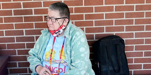 Pat Brown waits outside the Don Bosco Senior Center in Kansas City, Mo., Wednesday, March 3, 2021.  (AP Photo/Orlin Wagner)