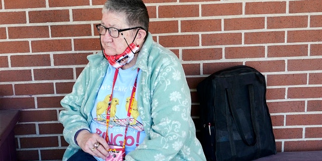 Pat Brown waits outside the Don Bosco Senior Center in Kansas City, Mo., Wednesday, March 3, 2021. (AP Photo/Orlin Wagner)