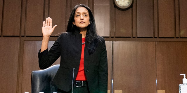 Vanita Gupta, left, nominated to be associate attorney general is sworn in before a hearing of the Senate Judiciary Committee on Capitol Hill, Tuesday, March 9, 2021, in Washington. (AP Photo/Alex Brandon)
