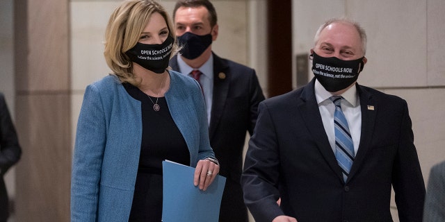 Rep. Ashley Hinson, R-Iowa, and Rep. Steve Scalise, R-La., the House minority whip, right arrive to talk to reporters, following a GOP strategy session, at the Capitol in Washington, Tuesday, March 9, 2021.