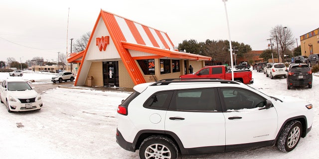Cars wrap around a Whataburger restaurant as queue to order food after a snow storm on February 17, 2021 in Fort Worth, Texas. Very few restaurants were open during the worst of Winter storm Uri, which brought historic cold weather and power outages to the Lone Star State.