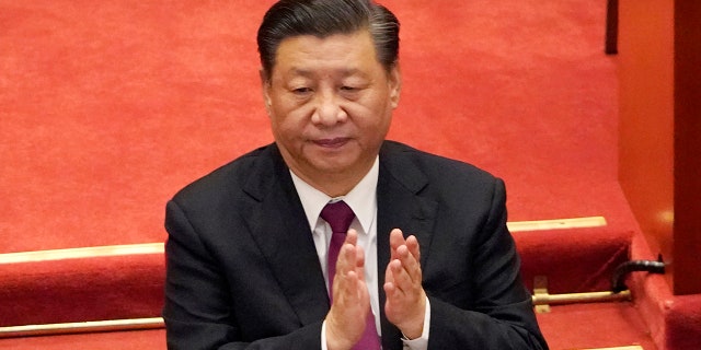 Chinese President Xi Jinping applauds during the closing session of the Chinese People's Political Consultative Conference (CPPCC) at the Great Hall of the People in Beijing, Wednesday, March 10, 2021.