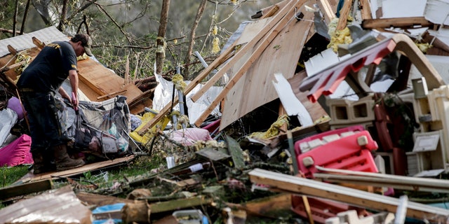 Residents begin the clean up process after a tornado touched down Friday, March 26, 2021 in Wellington, Ala. A tornado outbreak has ripped across the Deep South leaving paths of destruction. (AP Photo/Butch Dill)