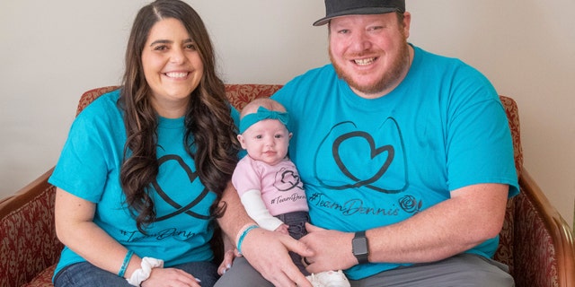 March 17, 2021: Jackie Dennis, left, and her husband, Ricky Dennis, pose for a photo with their daughter, Mia Rose, at Henry Ford Health System in Detroit.
