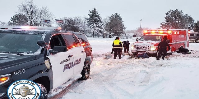 Police in Aurora, Colo., say two bystanders helped dig out this stuck ambulance on Sunday. (Aurora Police Department)