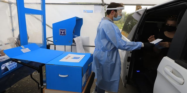 Coronavirus patients cast their ballots Tuesday at a special drive-through polling station in Israel. (Eitan Elhadez/TPS)