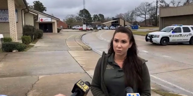 Casey Rayborn Hicks, public information officer for the East Baton Rouge Sheriff's Office, briefs the media at the scene of an attempted murder-suicide in Baton Rouge Tuesday.