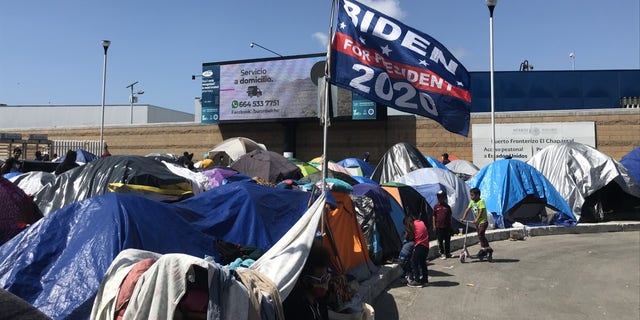 A "Biden for president 2020'" flag flies over a migrant camp on the U.S. southern border. Some migrants have said they chose to make the trip to the United States now because Biden won the presidential election. Biden has denied that his campaign rhetoric and policies are fueling the immigration surge. (Griff Jenkins/Fox News).