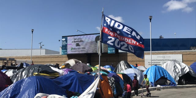 A "Biden for president 2020'" flag flies over a migrant camp on the U.S. southern border. Some migrants have said they chose to make the trip to the United States now because Biden won the presidential election. Biden has denied that his campaign rhetoric and policies are fueling the immigration surge. (Griff Jenkins/Fox News).