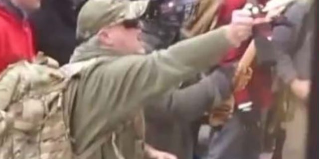 Court documents included a screenshot from a YouTube video allegedly showing Caldwell douse officers with a chemical spray. (FBI)