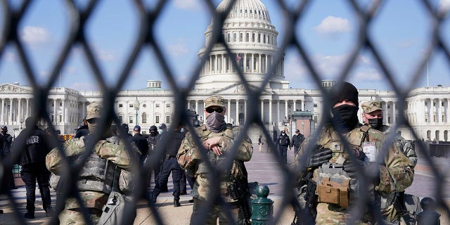 National Guard keep watch on the Capitol, Thursday, March 4, 2021, on Capitol Hill in Washington. Capitol Police say they have uncovered intelligence of a "possible plot" by a militia group to breach the U.S. Capitol on Thursday, nearly two months after a mob of supporters of then-President Donald Trump stormed the iconic building to try to stop Congress from certifying now-President Joe Biden's victory. (AP Photo/Jacquelyn Martin)