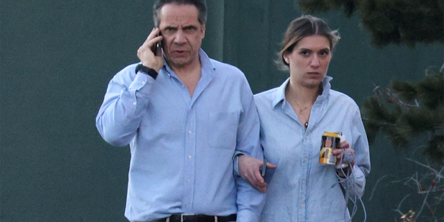 Governor Andrew Cuomo walks with daughter Mariah Kennedy-Cuomo in the grounds of the governor's house on March 12, 2021.  Cuomo's campaign reportedly helped increase sales of the governor's book by sending at least one note to his email list signed on behalf of Cuomo's children. 