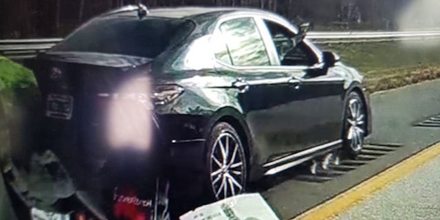 In this screengrab from the victims' dashcam video, a suspect can be seen firing a gun out of a moving vehicle.