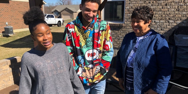 March 7, 2021: Brilee Carter, left,13, and Cobe Calhoun, 17, share a laugh with their great-grandmother, Doris Rolark, outside Rolark's daughter's home in Monroe, Ohio.