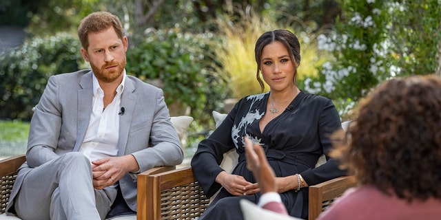 This image provided by Harpo Productions shows Prince Harry, from left, and Meghan, Duchess of Sussex, in conversation with Oprah Winfrey. 