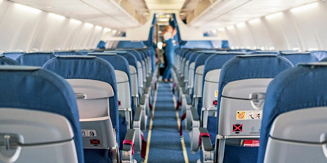 An empty airplane cabin interior. Professor Ed Galea recommends being aware of your surroundings before heading to your seat while boarding.