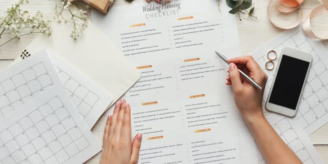 Woman reviews wedding planning checklist.