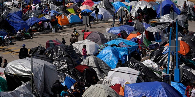 A makeshift camp of migrants sits at the border port of entry leading to the United States, Wednesday, March 17, 2021, in Tijuana, Mexico. (AP Photo/Gregory Bull)