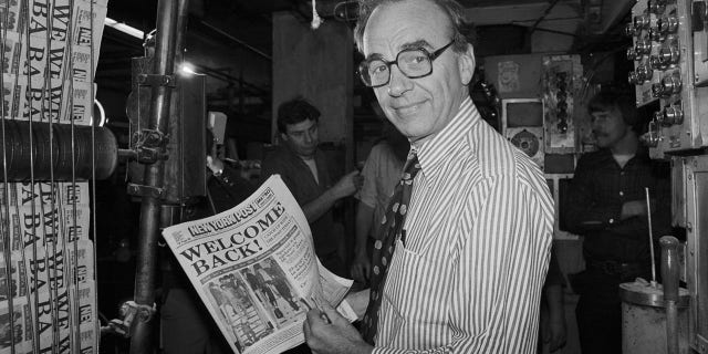 Rupert Murdoch holding up a copy of the New York Post in 1978. (File)