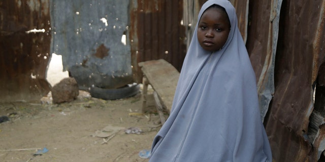 Student Amtallahi Lawal, 11, who hid under her bed and managed to escape when gunmen abducted more than 300 girls from her boarding school on Friday, recounts her ordeal at her house in Jangebe town, Zamfara state, northern Nigeria, Monday, March 1, 2021. Families in Nigeria waited anxiously on Monday for news of their abducted daughters, the latest in a series of mass kidnappings of school students in the West African nation. (AP Photo/Sunday Alamba)