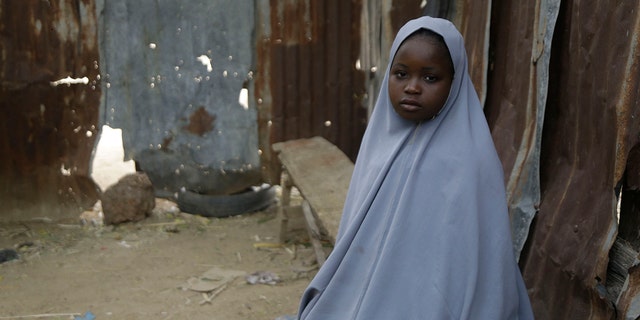 Student Amtallahi Lawal, 11, who hid under her bed and managed to escape when gunmen abducted more than 300 girls from her boarding school on Friday, recounts her ordeal at her house in Jangebe town, Zamfara state, northern Nigeria, Monday, March 1, 2021. Families in Nigeria waited anxiously on Monday for news of their abducted daughters, the latest in a series of mass kidnappings of school students in the West African nation. (AP Photo/Sunday Alamba)
