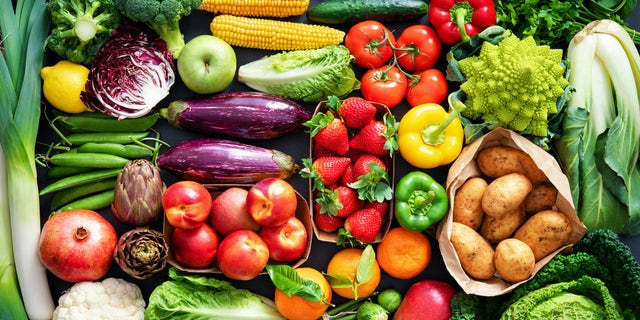 An assortment of fresh, healthy, organic fruits and vegetables is displayed. 