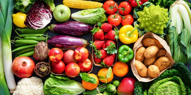 An assortment of fresh, healthy, organic fruits and vegetables is displayed. 