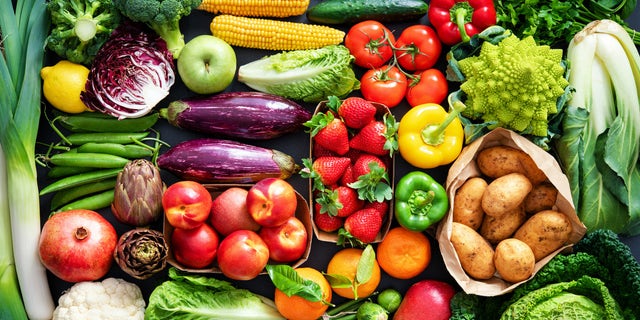 An assortment of fresh, healthy, organic fruits and vegetables are shown. 