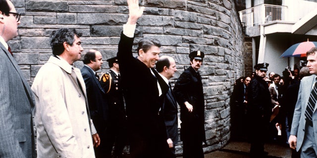 This photo taken by presidential photographer Mike Evens on March 30, 1981 shows President Ronald Reagan waving to the crowd just before the assassination attempt on him, after a conference outside the Hilton Hotel in Washington, D.C.. Reagan was hit by one of six shots fired by John Hinckley, who also seriously injured press secretary James Brady (just behind the car). Reagan was hit in the chest and was hospitalized for 12 days. Hinckley was aquitted 21 June 1982 after a jury found him mentally unstable.