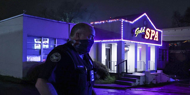 City of Atlanta Police Officer Davis works at the scene outside of Gold Spa after deadly shootings at a massage parlor and two day spas in the Atlanta area, in Atlanta, Georgia, U.S. March 16, 2021. (REUTERS/Chris Aluka Berry)